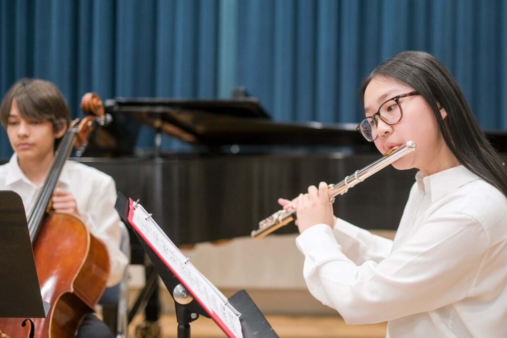 Girl playing flute with boy playing cello