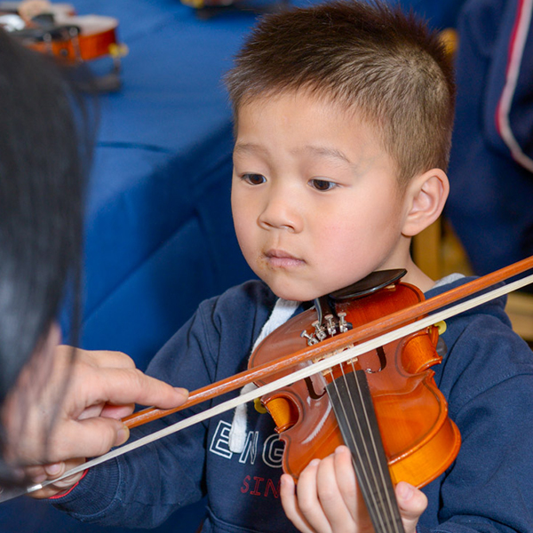 young Asian boy playing the violin