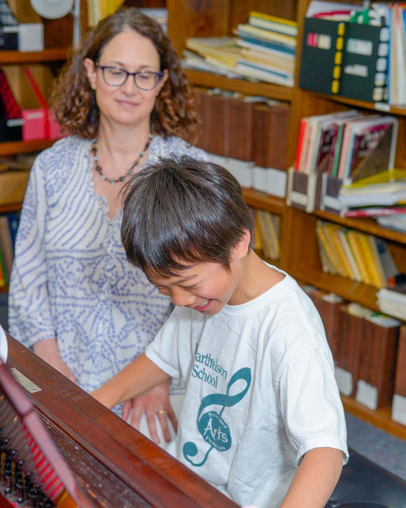 Young boy taking a piano lesson