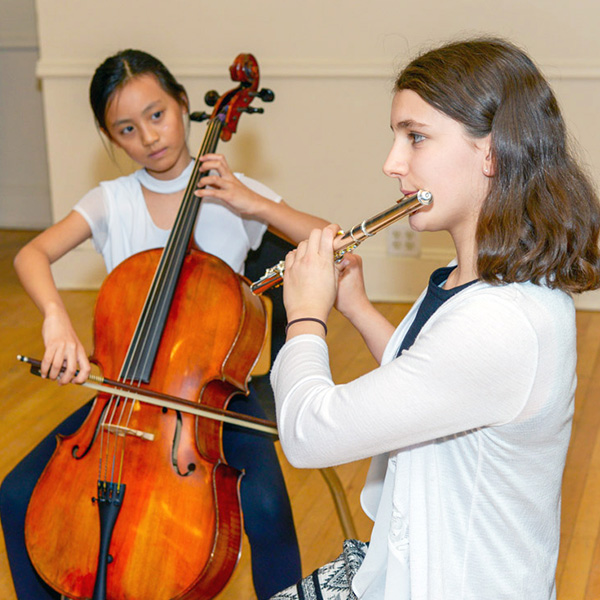 Girl playing the cello with girl playing the flute