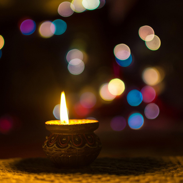 Candle with sparking lights surrounding it