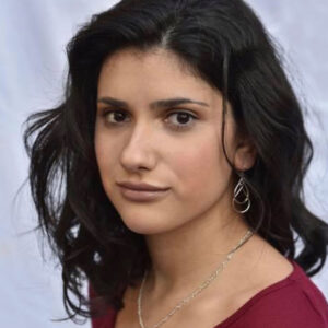 Young woman with dark shoulder length hair and a red shirt