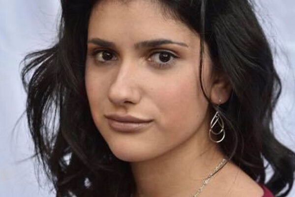 Young woman with dark shoulder length hair and a red shirt