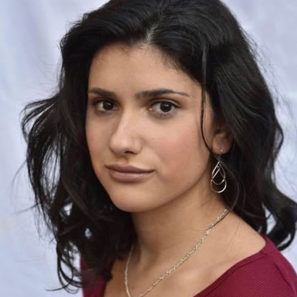 Young woman with dark shoulder length hair and a red shirt
