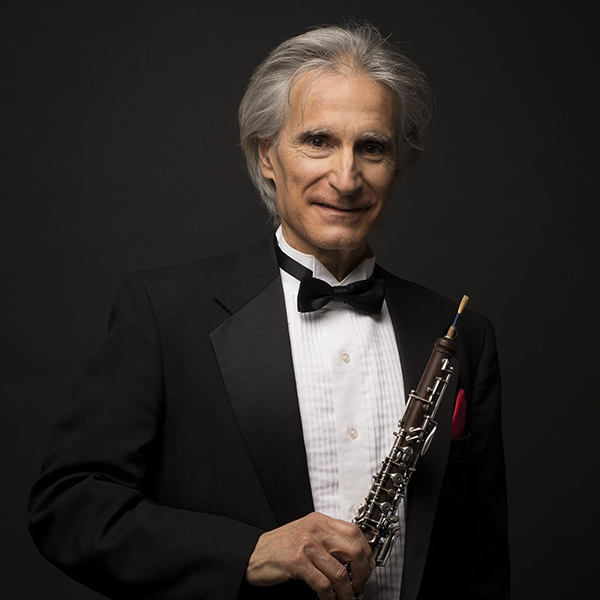 Man in tuxedo holding oboe