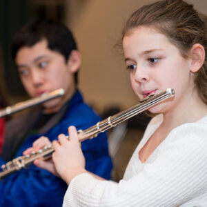 Young boy and girl playing the flute