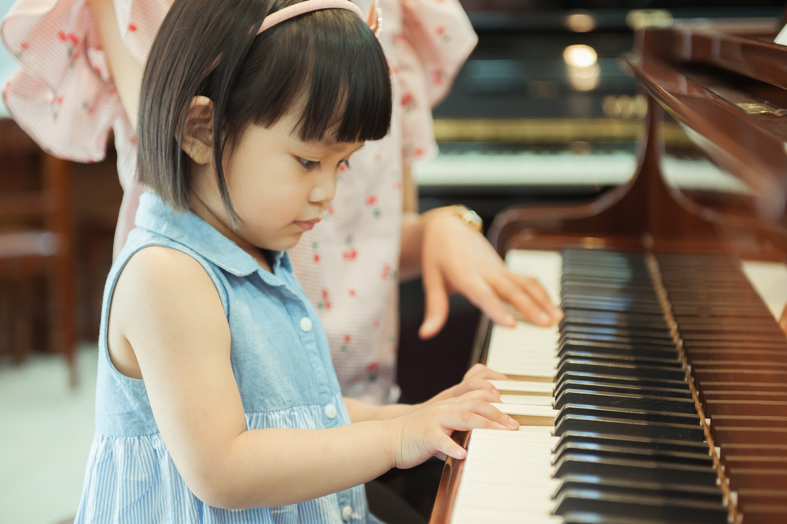 Young Asian Girl playing the piano